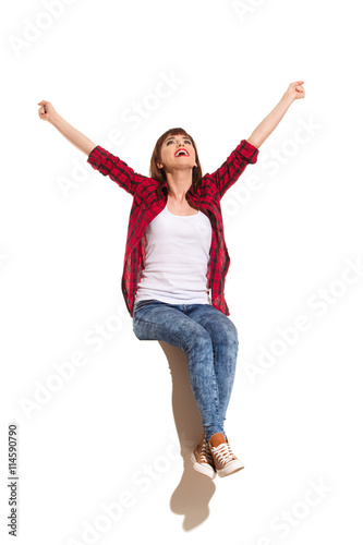 Happy Woman Sitting On A Top And Celebrating