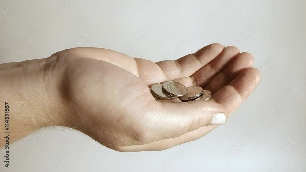 Silver coins falling to hand. Economic and financial theme. Money for you.