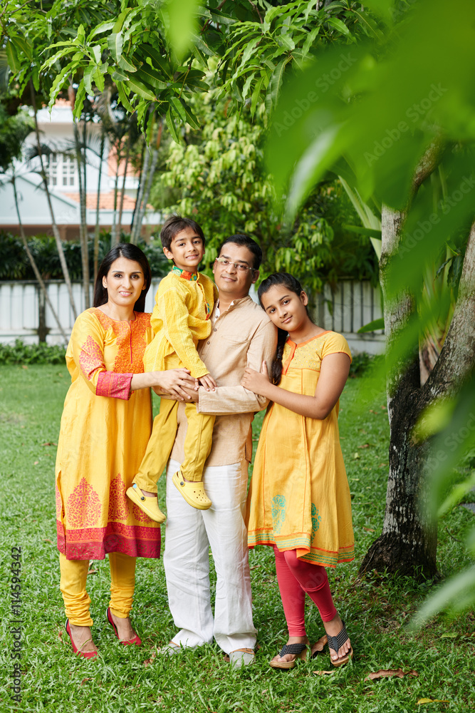 Happy Indian family or four in national costumes
