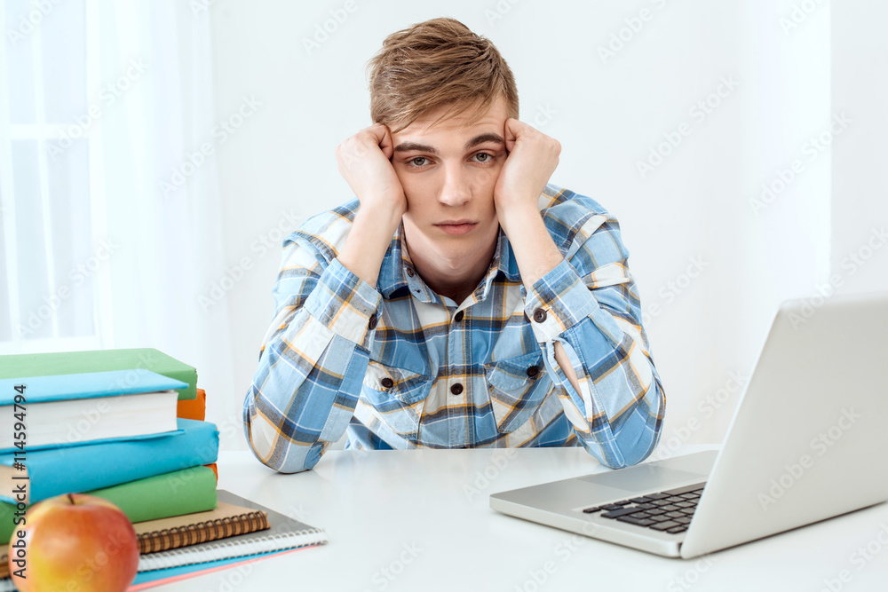 Cute young student using laptop