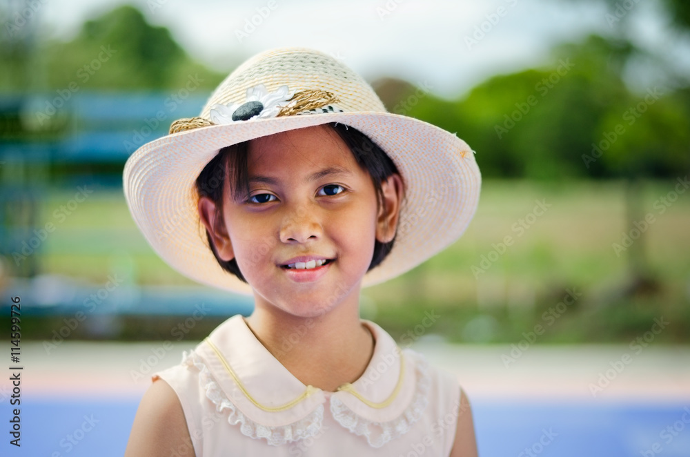 Asian kid beautiful smile.She wore a hat