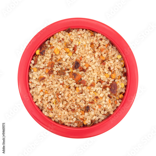 Small dish filled with salt, red chili pepper and paprika top view isolated on a white background.