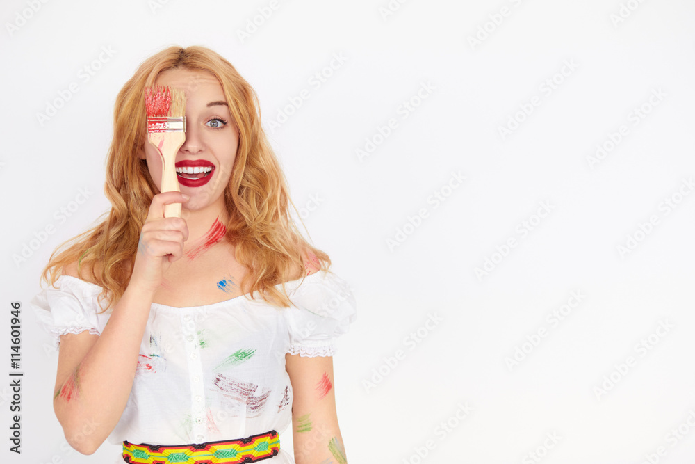 young blond woman painter holding a paint brush young blond woman painter holding a paint brush