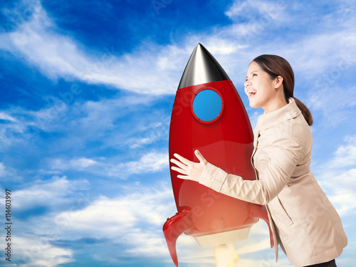 start up concept with asian woman hanging with space shuttle photo