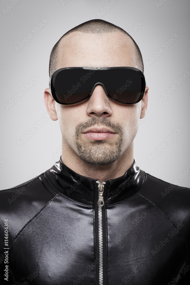 Fototapeta premium Portrait of futuristic man with sunglasses over white background