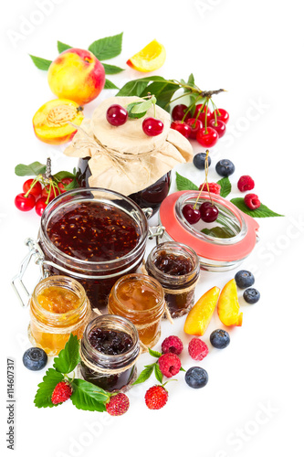 Different berry jam in glass jar