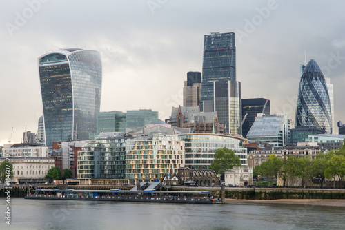 Wall Mural Futuristic skyscrapers in city of london  on a cloudy day along river Thames
