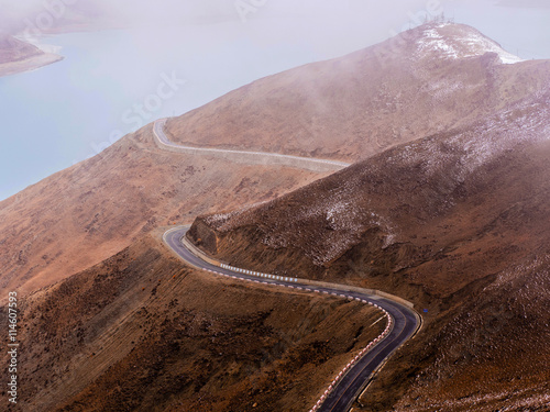 Curved asphalt road in high mountains of Tibet