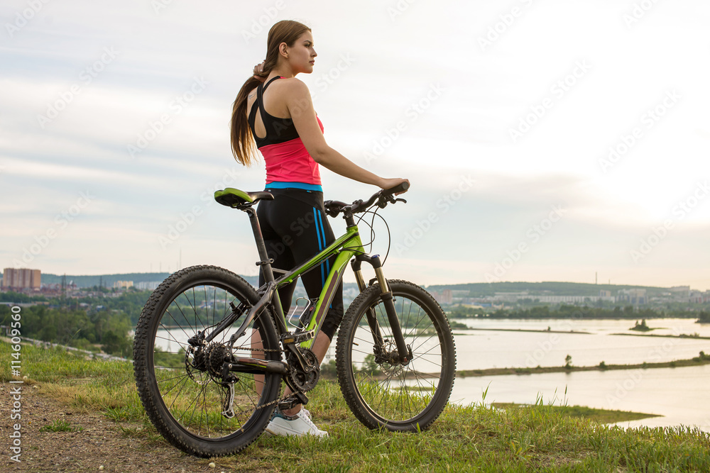 Woman cyclist on a mountain bike