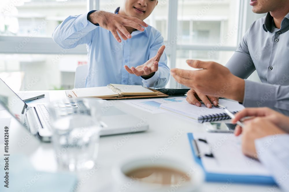 Businessman explaining his idea to colleague, selective focus Businessman explaining his idea to colleague, selective focus