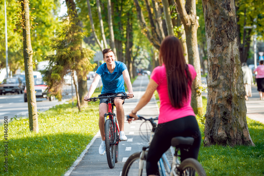 Cycling young couple.