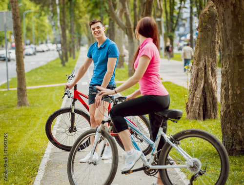 Cycling young couple.