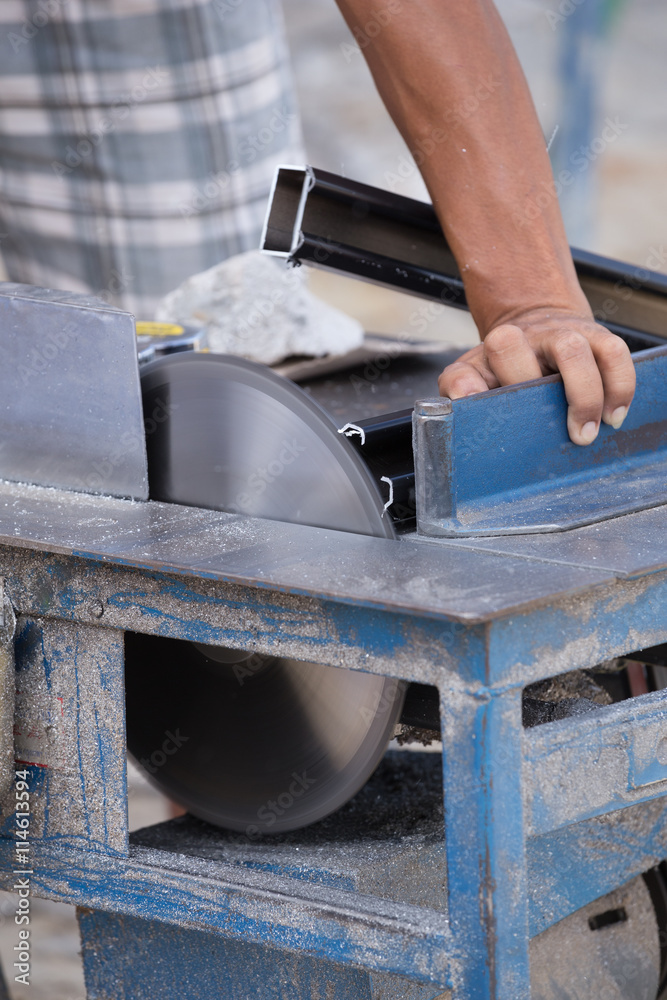 Worker cutting aluminium with grinder blade Worker cutting aluminium with grinder blade