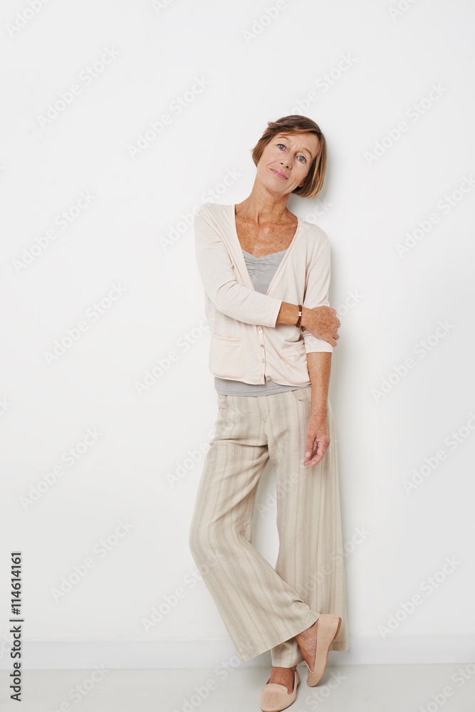 Portrait of mature woman in casual clothes leaning on wall Portrait of mature woman in casual clothes leaning on wall