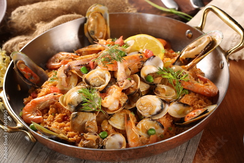 Pan of fried rice with clams, oysters and shrimps