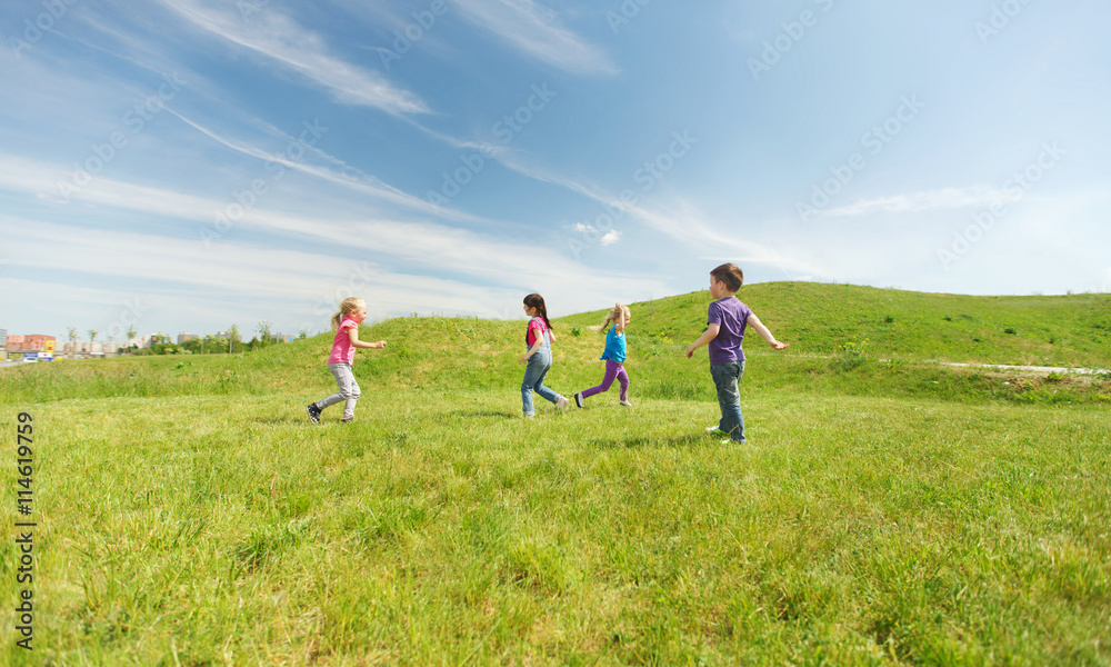 group of happy kids running outdoors