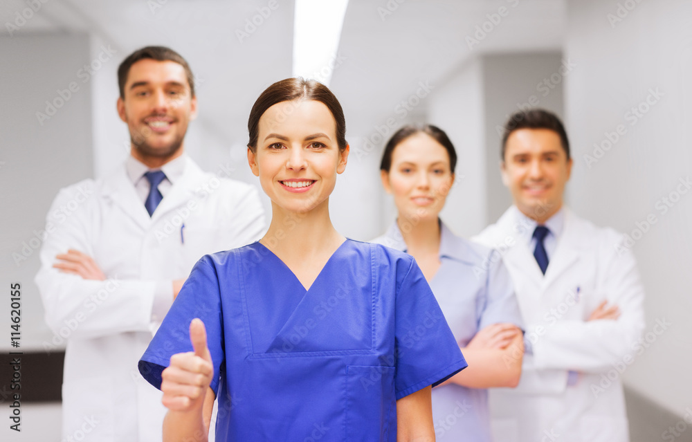 medics or doctors at hospital showing thumbs up medics or doctors at hospital showing thumbs up