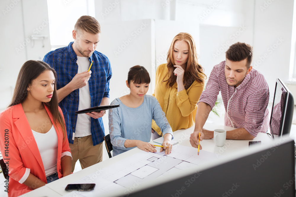 Fototapeta premium creative team with blueprint working at office