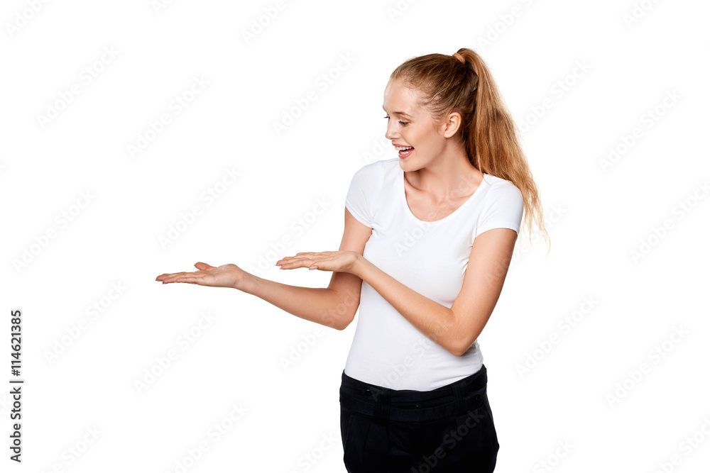 Smiling woman showing open hand palm with copy space Smiling woman showing open hand palm with copy space