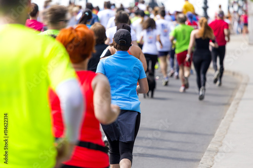 marathon runners in colorful sportswear running on the street