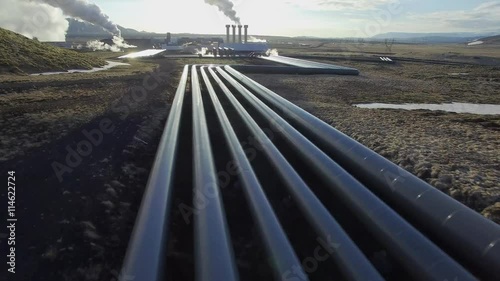 Aerial view of a geothermal power plant in Iceland. flying low over the pipeline leading hot water to the plant for power generation