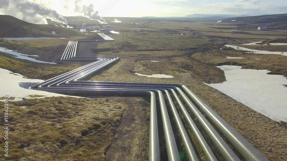 Aerial view of a geothermal power plant in Iceland. flying low over the pipeline leading hot water to the plant for power generation