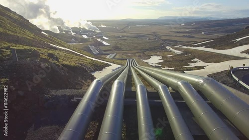 Aerial view of a geothermal power plant in Iceland. flying low over the pipeline leading hot water to the plant for power generation