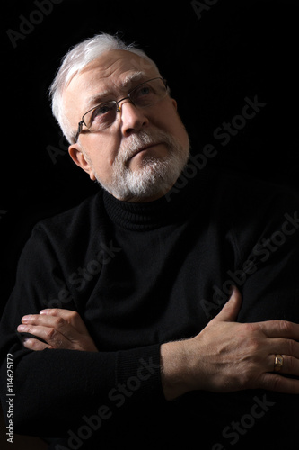 classic portrait of a beautiful elderly man on a black background