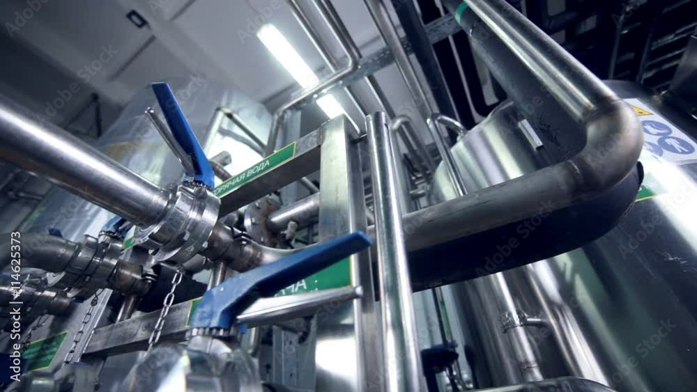Pipelines with valves at modern plant, factory indoor. Pipelines with valves at modern plant, factory indoor.