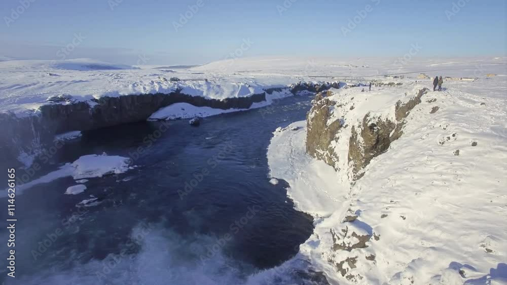Aerial ultra high definition video of Godafoss waterfall in Iceland. Footage shot in winter with snow on the ground. Shoot with a DJI phantom pro. Drone travels downriver and over the waterfall itself Aerial ultra high definition video of Godafoss waterfall in Iceland. Footage shot in winter with snow on the ground. Shoot with a DJI phantom pro. Drone travels downriver and over the waterfall itself