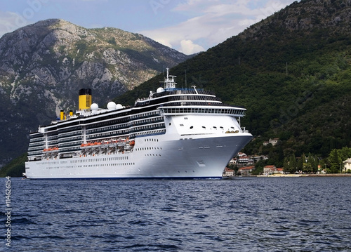 sea liner runs along the mountainous coast line
