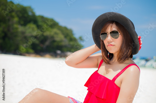 Woman in action on the beautiful beach at koh tachai photo