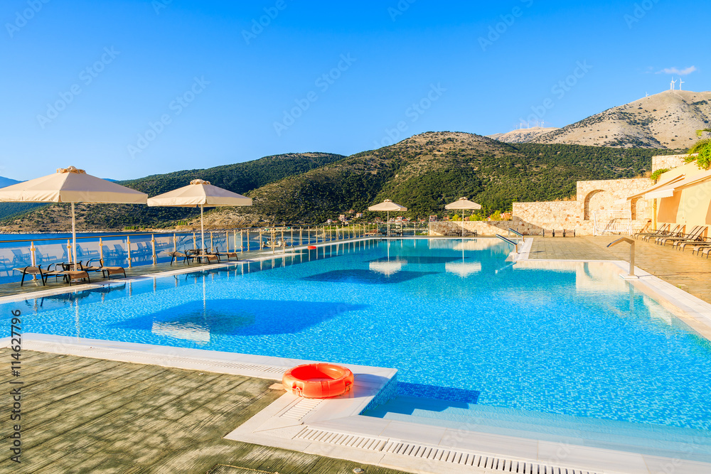 Swimming pool with sea and mountain view on coast of Kefalonia island in Agia Efimia village, Greece
