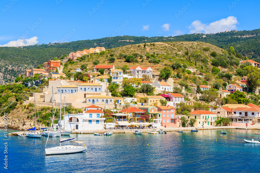 Colorful houses of Assos village and yacht boats in port on Kefalonia island, Greece