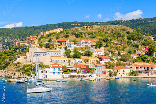 Fototapeta Naklejka Na Ścianę i Meble -  Colorful houses of Assos village and yacht boats in port on Kefalonia island, Greece