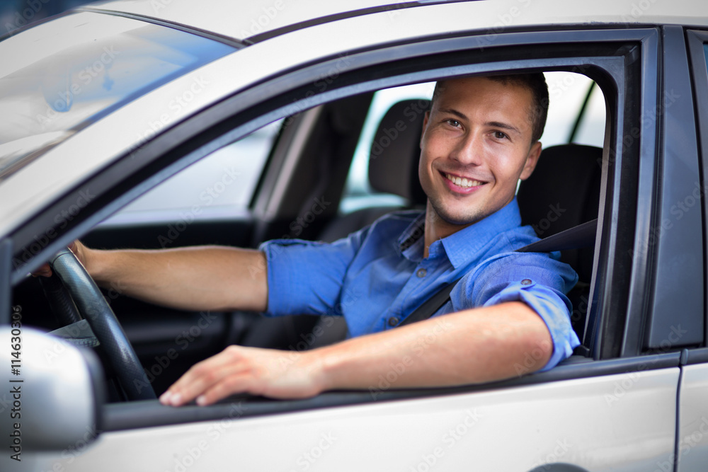 Young man sitting in a car 
