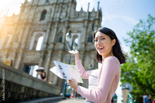 Woman holding city guide in Macao city