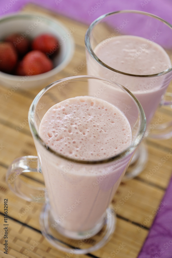 Milkshake with strawberries in a glass