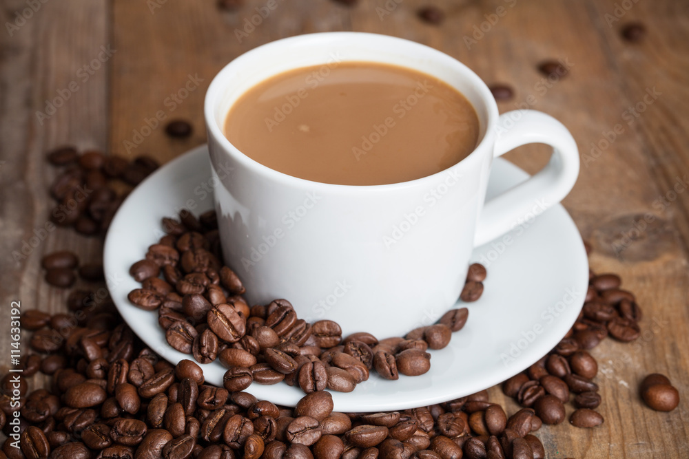 Coffee cup with wooden background with coffee beans Coffee cup with wooden background with coffee beans