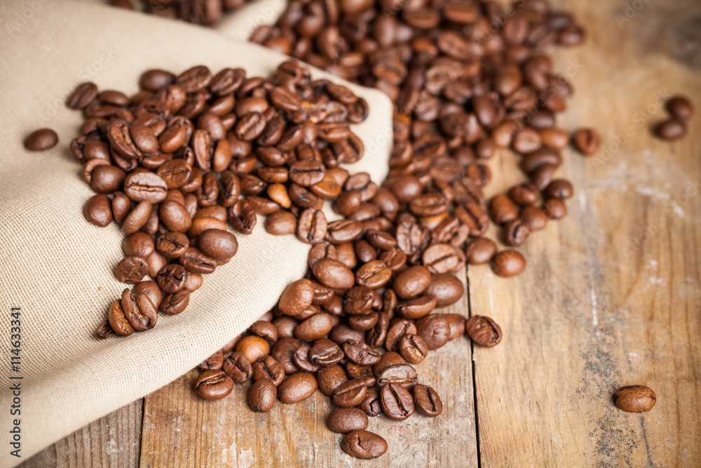 Coffee beans on wood background. Selective focus. Coffee beans on wood background. Selective focus.