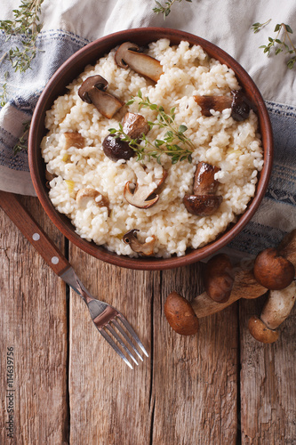 risotto with porcini mushrooms and thyme close-up. Vertical top view
