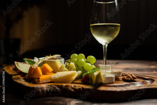 fruit dish with white wine served on desk