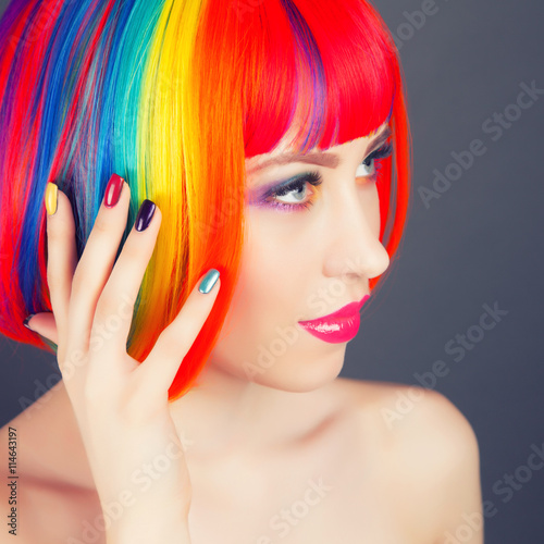 beautiful woman wearing colorful wig and showing colorful nails