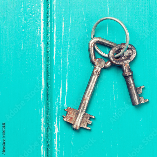 old key on a blue wooden background © merydolla