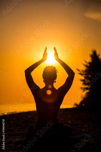 a man in the lotus position silhouette