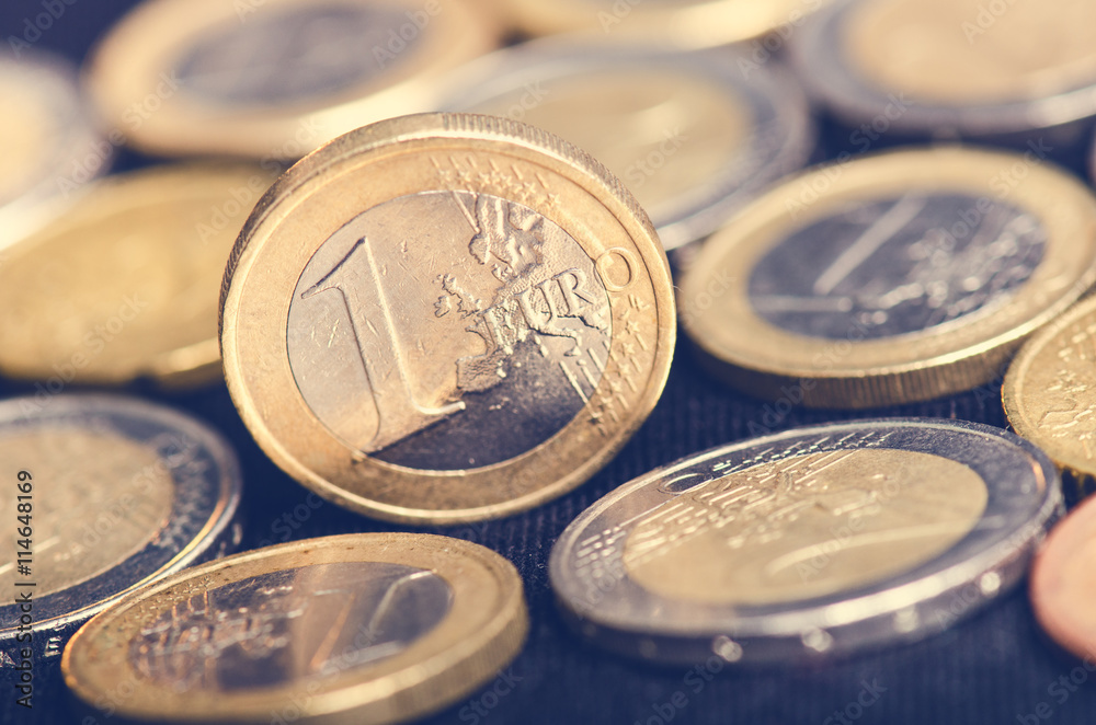 Euro money. Coins are isolated on a dark background. Currency of Europe. Balance of money. Coins values of one and two euro. Euro money. Coins are isolated on a dark background. Currency of Europe. Balance of money. Coins values of one and two euro.