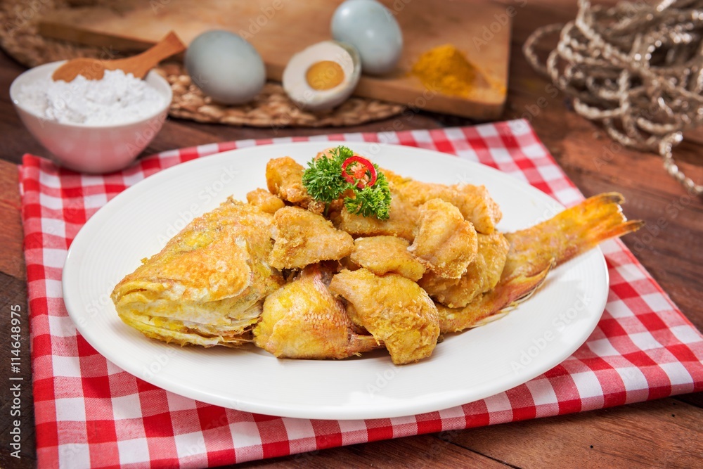 Plate of fried fish on the table in restaurant