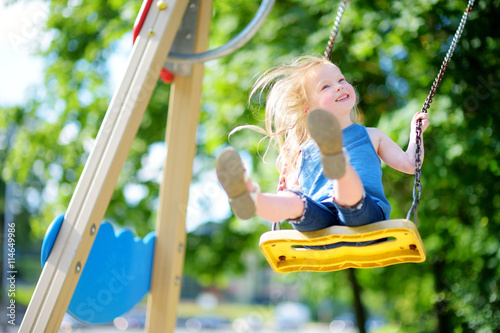Photography Cute little girl having fun on a playground