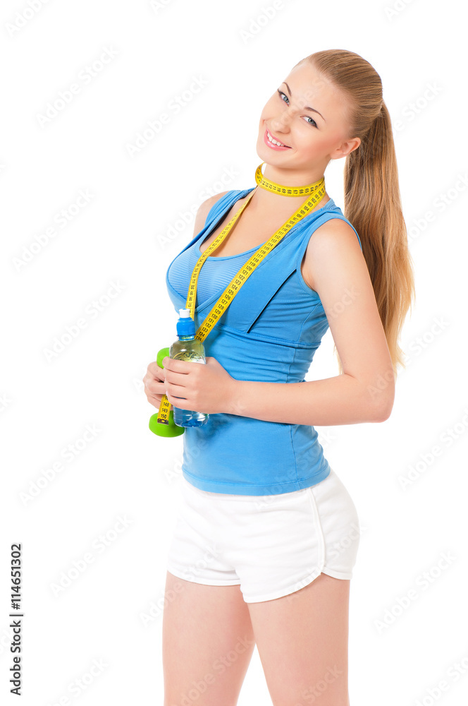 Woman exercising with dumbbell, bottle of water and measuring tape, portrait isolated over white background Woman exercising with dumbbell, bottle of water and measuring tape, portrait isolated over white background