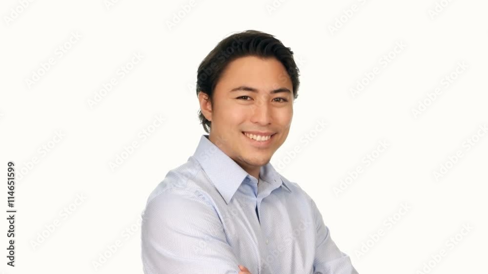 Trendy attractive man wearing a light blue shirt, smiling and walking towards camera in front of a white background. Trendy attractive man wearing a light blue shirt, smiling and walking towards camera in front of a white background.
